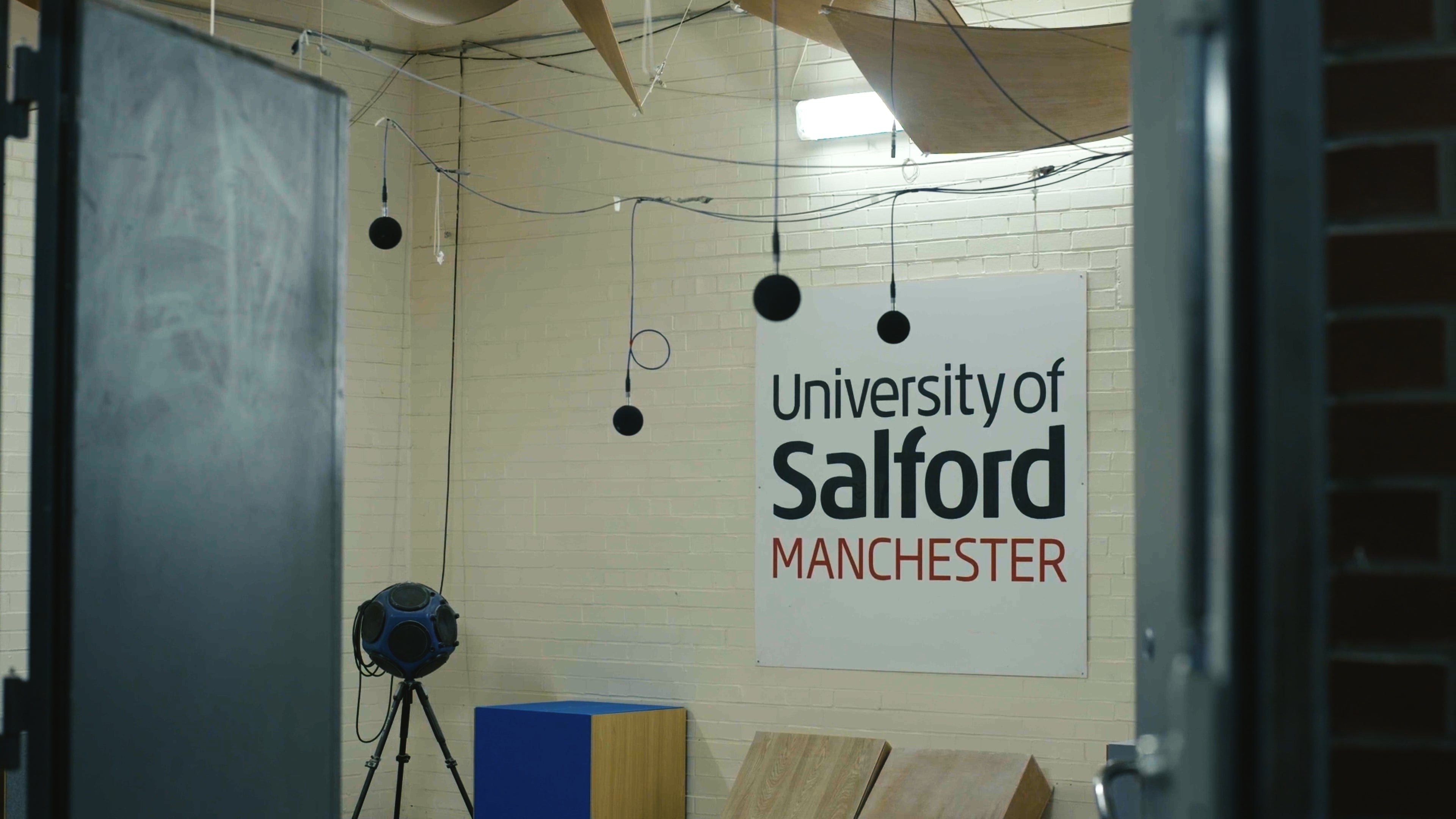 sign reading "University of Salford Manchester"