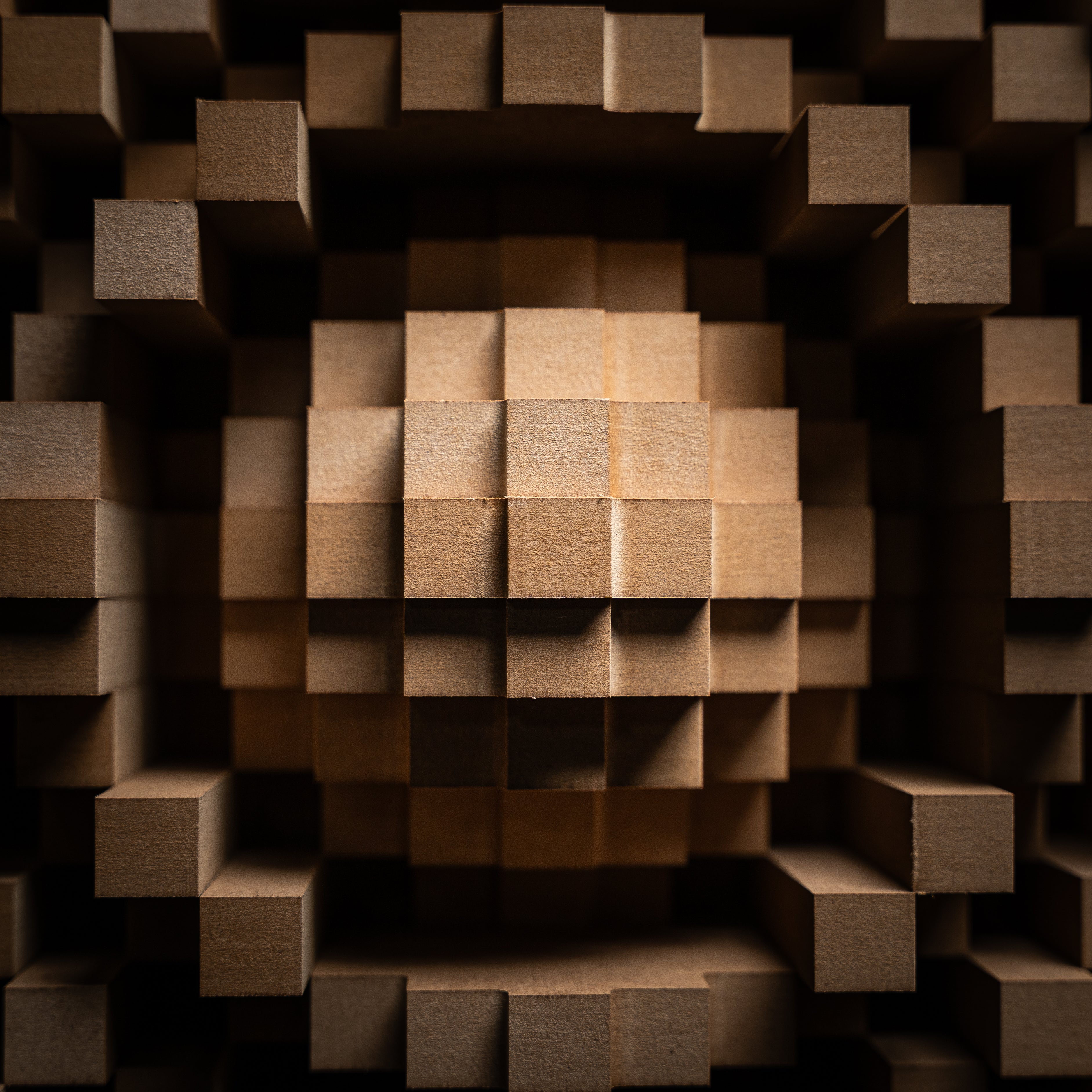 Close-up detail of the GIK Acoustics Gotham Primitive Root Diffuser, showing its varying-depth wooden wells arranged in a mathematically calculated pattern.